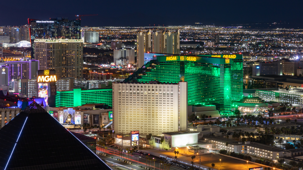A nighttime cityscape of the Las Vegas Strip, featuring the brightly lit, green-accented MGM Grand hotel and surrounding buildings—an inspiring scene reminiscent of Marnoa Private Wealth Counsel’s expert wealth management and financial planning.
